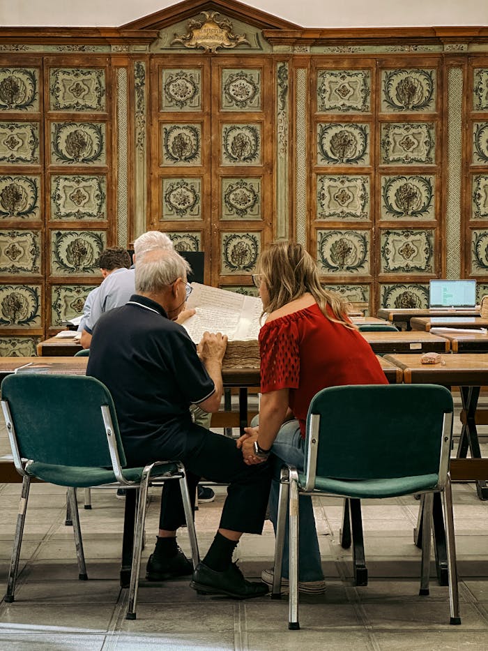 People studying in a historic library in Palermo, showcasing Italian architecture.